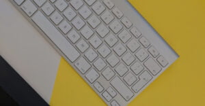 Close up of keyboard over yellow, black, and white background