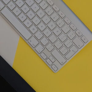Close up of keyboard over yellow, black, and white background