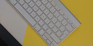 Close up of keyboard over yellow, black, and white background