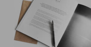 Close up of open booklet with pen on top of page