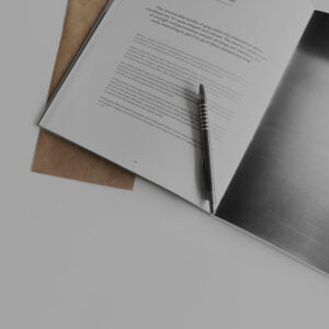 Close up of open booklet with pen on top of page