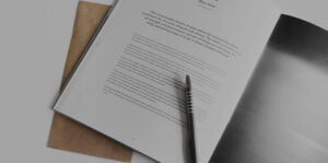 Close up of open booklet with pen on top of page