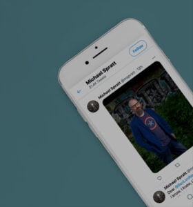 Close up of iPhone with Michael Spratt Twitter feed